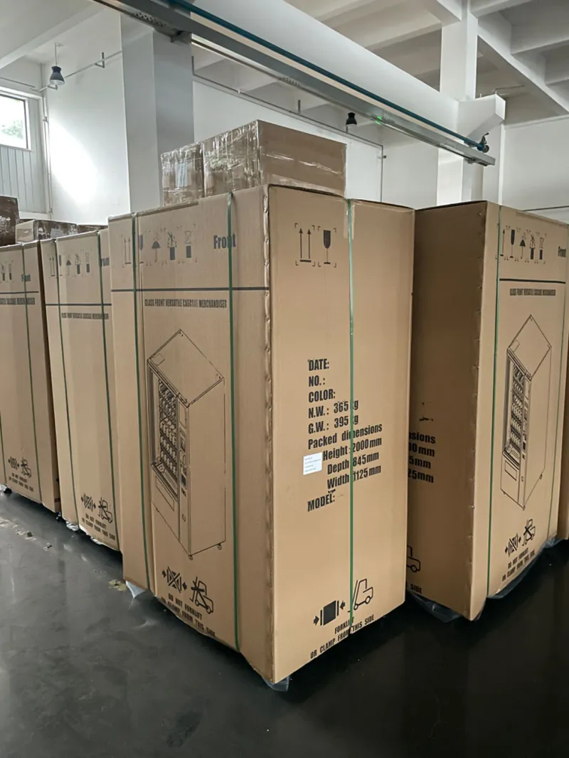 Stacked custom vending machine cartons in factory warehouse, ready for shipping